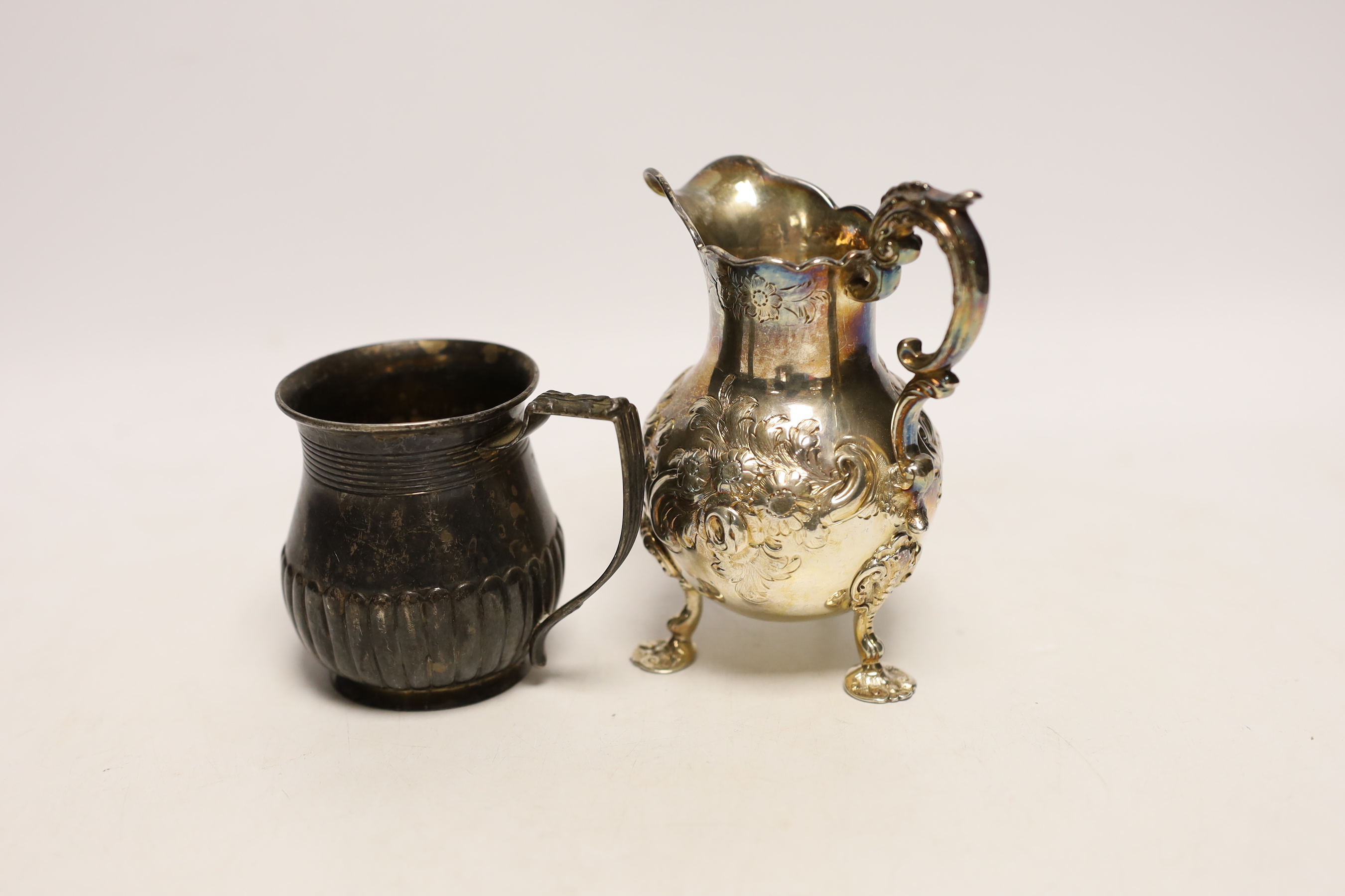 A George III demi fluted silver christening mug, by Emes & Barnard, London, 1814, 76mm, together with a later embossed silver cream jug, London, 1851, 9.8oz.